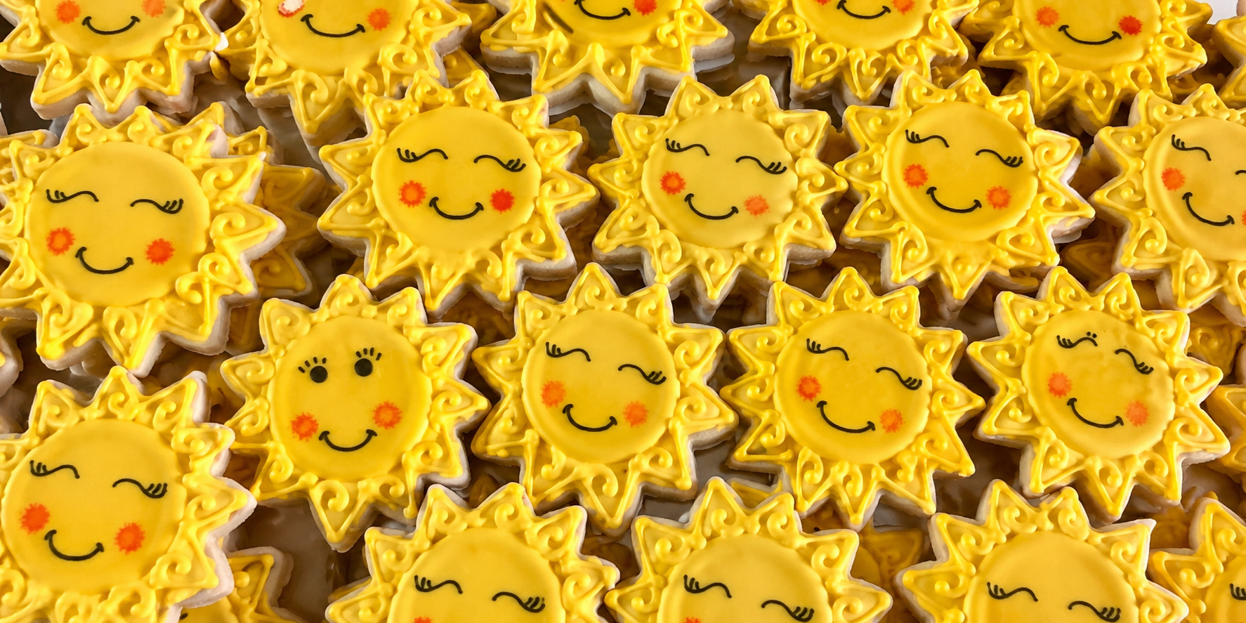Yellow sun and star smiley-face decorated cookies made with 3D-printed cookie cutters